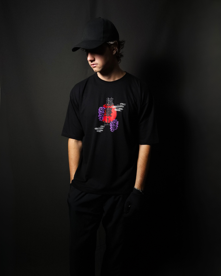 Anime-inspired apparel featuring bold back artwork, worn by a model in a dark studio setting – from a South African anime clothing brand.