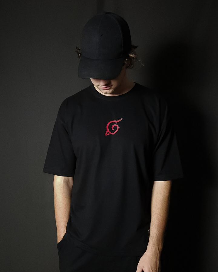 Anime-inspired apparel featuring bold Naruto back artwork, worn by a model in a dark studio setting – from a South African anime clothing brand.
