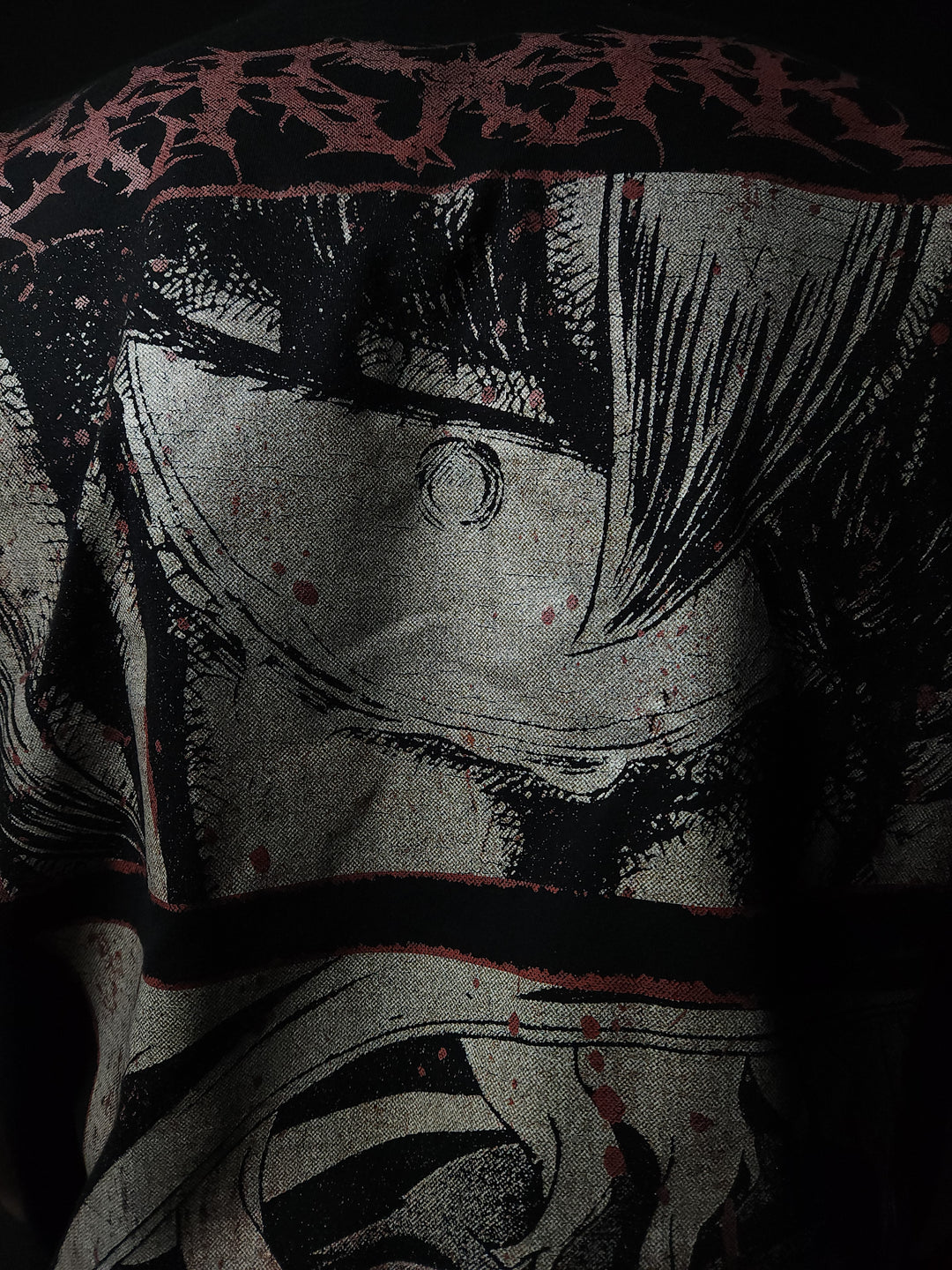 Anime-inspired apparel featuring bold back artwork, worn by a model in a dark studio setting – from a South African anime clothing brand.