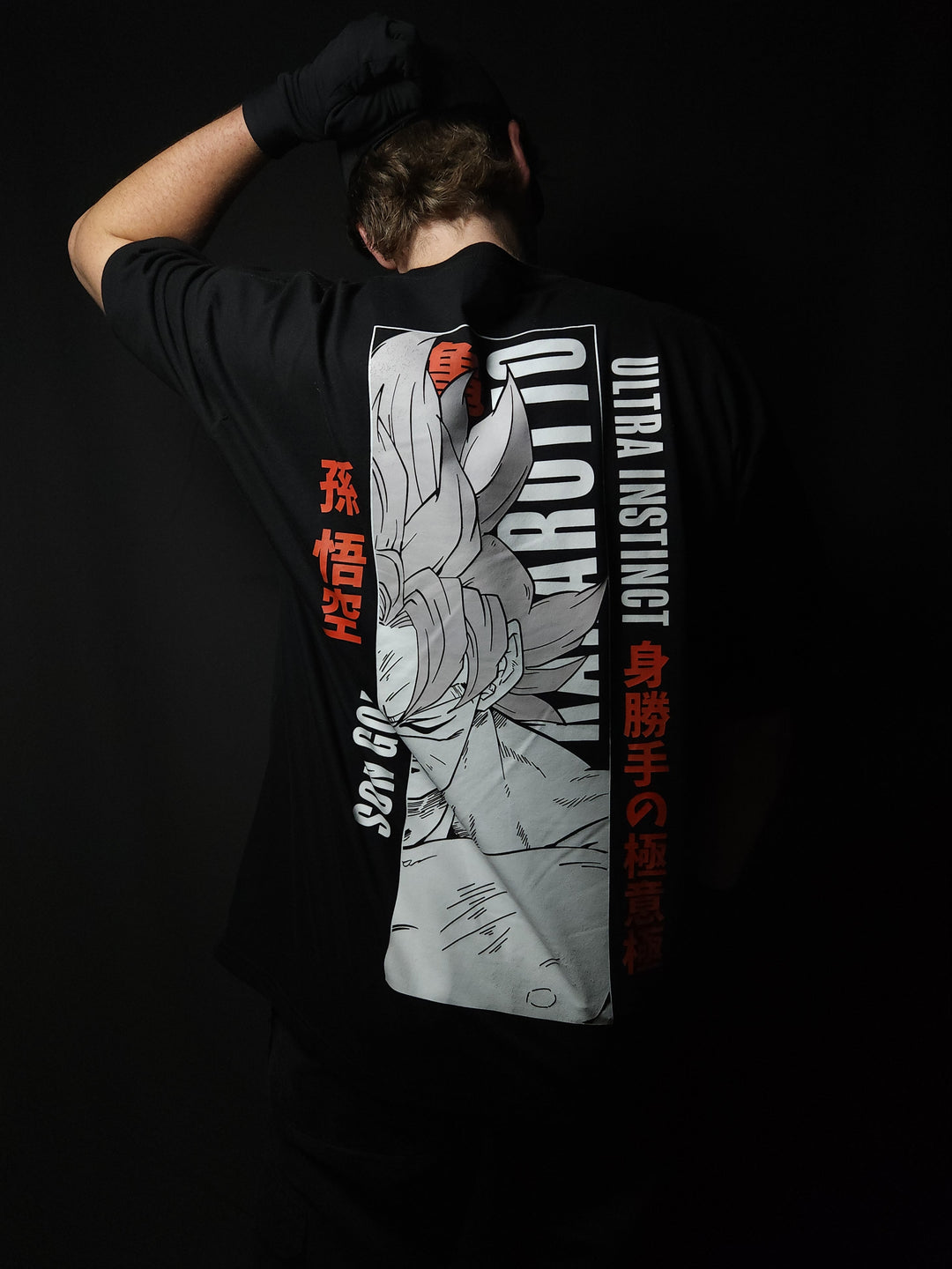 Anime-inspired apparel featuring bold back artwork, worn by a model in a dark studio setting – from a South African anime clothing brand.