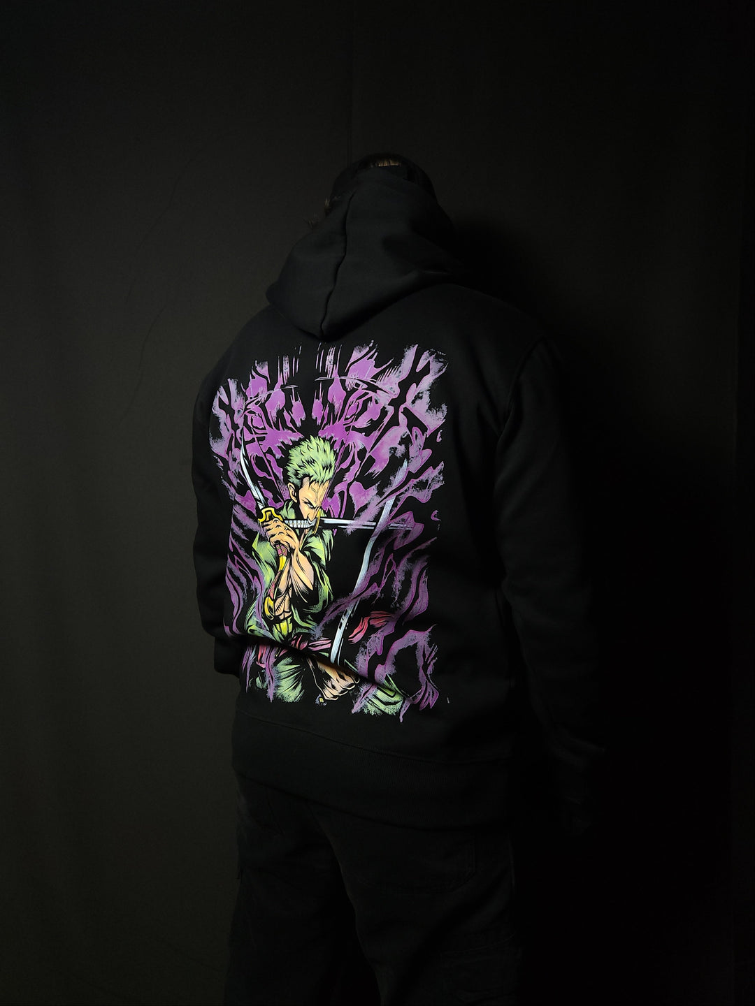 Anime-inspired apparel featuring bold back artwork, worn by a model in a dark studio setting – from a South African anime clothing brand.