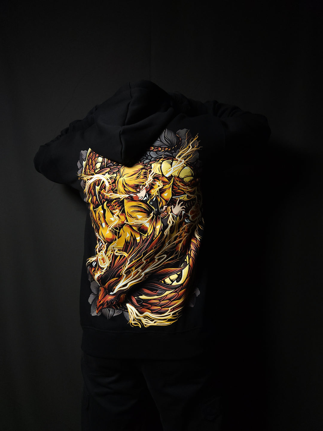 Anime-inspired apparel featuring bold back artwork, worn by a model in a dark studio setting – from a South African anime clothing brand.