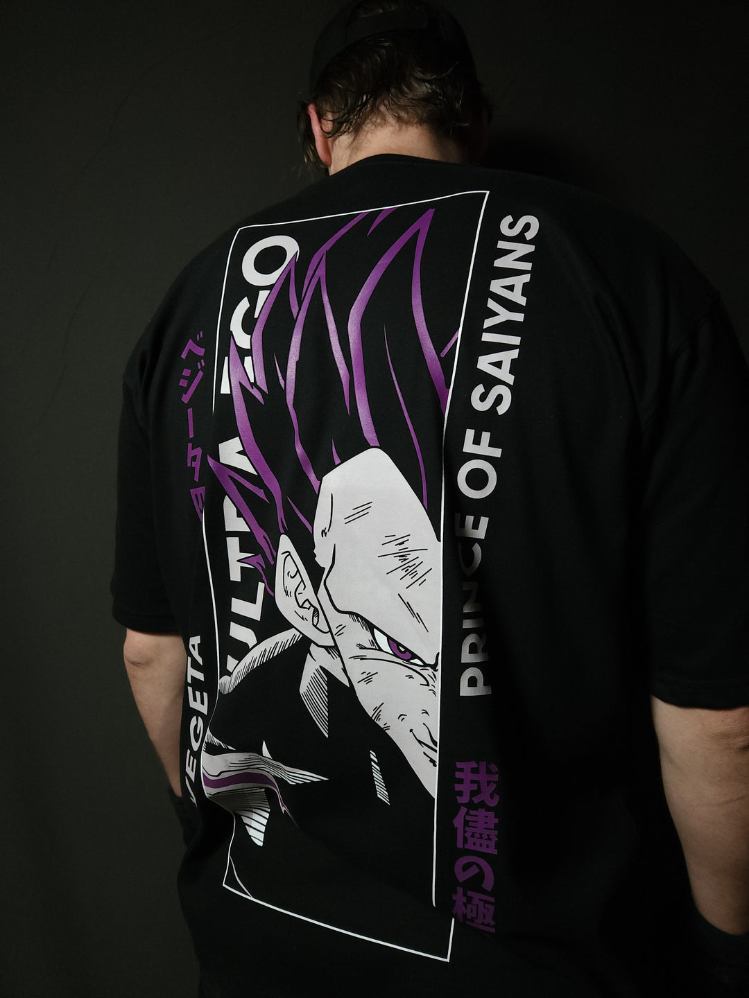 Anime-inspired apparel featuring bold back artwork, worn by a model in a dark studio setting – from a South African anime clothing brand.