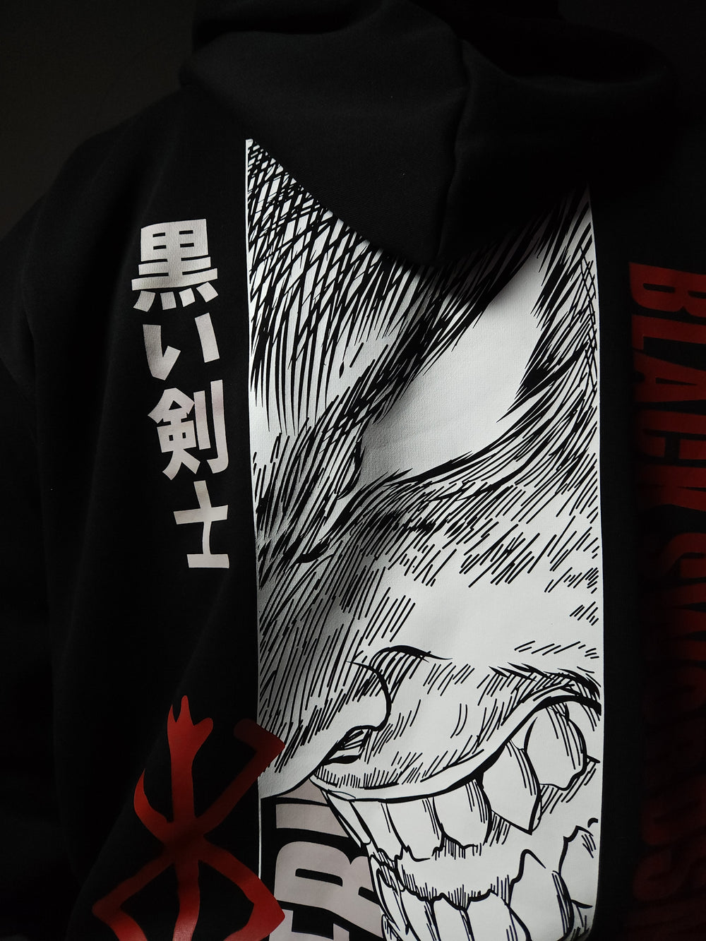 Anime-inspired apparel featuring bold back artwork, worn by a model in a dark studio setting – from a South African anime clothing brand.