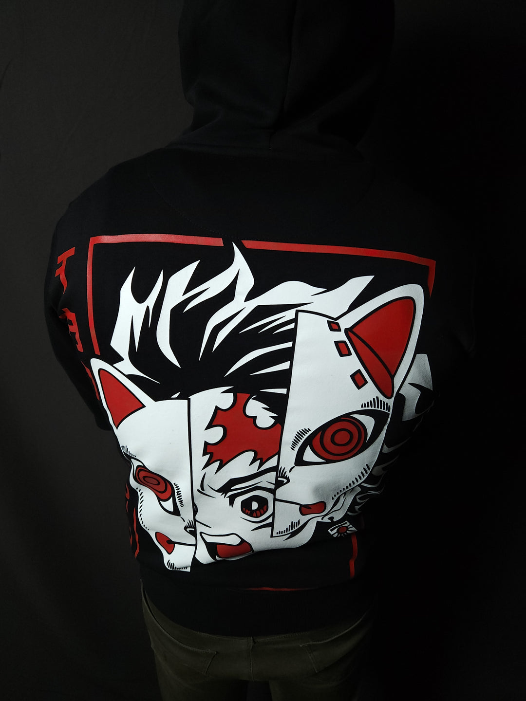 Anime-inspired apparel featuring bold back artwork, worn by a model in a dark studio setting – from a South African anime clothing brand.