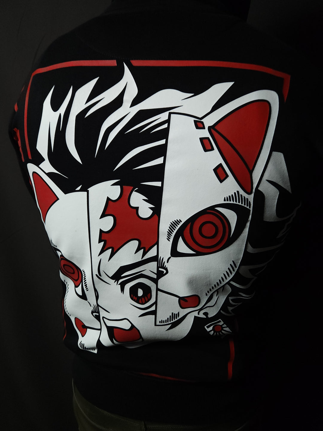 Anime-inspired apparel featuring bold back artwork, worn by a model in a dark studio setting – from a South African anime clothing brand.