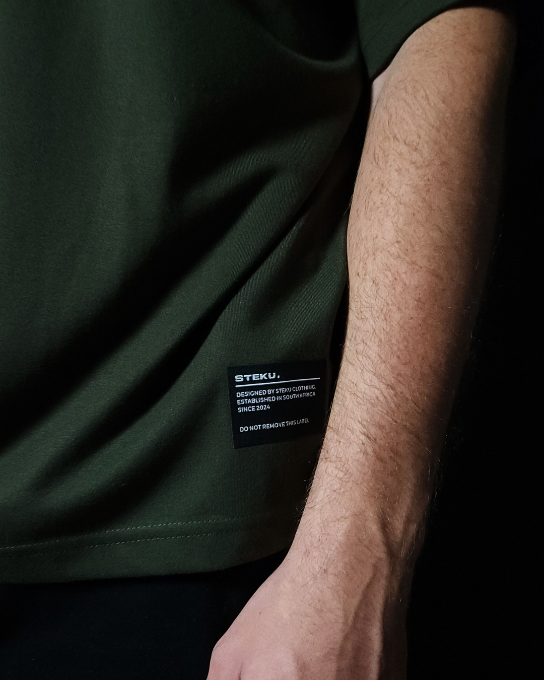 Anime-inspired apparel featuring bold Naruto back artwork, worn by a model in a dark studio setting – from a South African anime clothing brand.