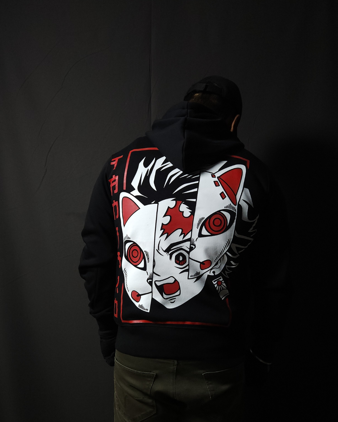 Anime-inspired apparel featuring bold back artwork, worn by a model in a dark studio setting – from a South African anime clothing brand.
